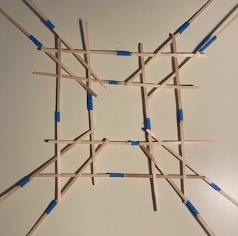 First step of weaving the cube. The hexagons are distorted to be made from right angles, allowing the woven sticks to lay flat